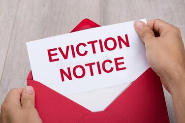 person-holding-eviction-notice-envelope-close-up-s-hand-red-124517309.jpg