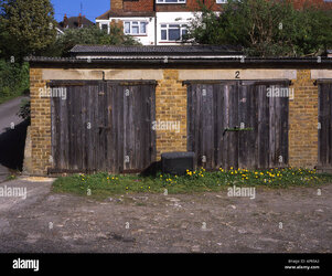 lock-up-garages-with-wooden-doors-and-a-broken-tv-on-the-ground-AP93A3.jpg